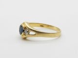 a gold ring with a sapphire stone and a diamond