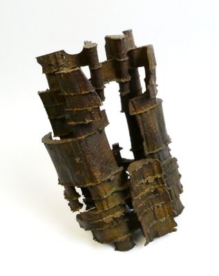 a sculpture made out of wood sticks on a white surface