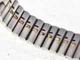 a close up of a watch on a white surface