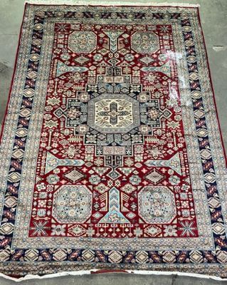 a red and blue rug with a medallion design on it