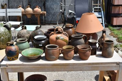 many different types of pottery sitting on a table
