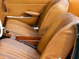 a close up of a car with leather seats and a steering wheel