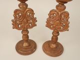 two wooden candlesticks that are sitting on a table