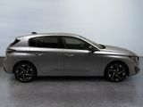 the silver car is parked on the concrete floor in the room