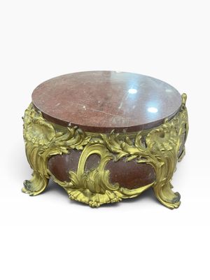 a small table with a marble top on a white background