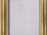 a gold frame on a white wall with a white background