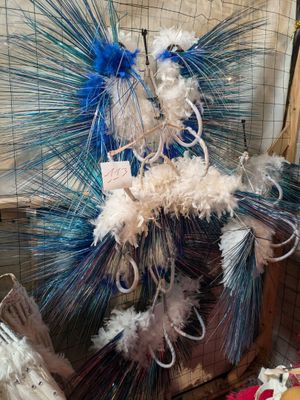 a blue and white feathered sculpture on display in a room