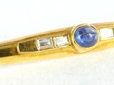 an image of a blue stone and diamond pen on a white surface