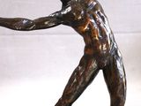 statue of a man holding a tennis racquet on a marble base