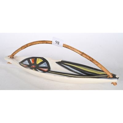 une image représentant une sculpture en forme de bateau munie d'une poignée en bois