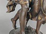 bronze statue of a woman holding a child on a base