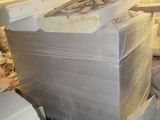 a pile of white boxes in the middle of a room