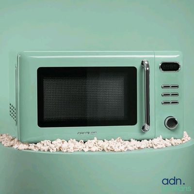 un micro-ondes vert posé sur une table