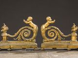 pair of antique brass figurines of angels on a bench