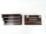 two pieces of wood are sitting next to each other on a white surface