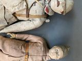 two dolls that are laying next to each other on the floor