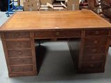 a wooden desk with drawers on it in a room