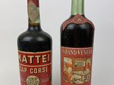 two bottles of wine sitting next to each other on a white surface