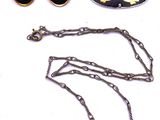several pieces of jewelry including a necklace, earrings, and a broochet