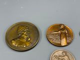 four coins are shown on a table with one of them in the foreground