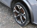 a close up of a car tire on a gravel road