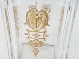 a glass vase with a gold design on it