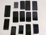 a lot of cell phones that are sitting on a table