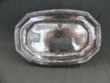 a silver tray with a bear in it on a table