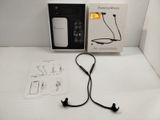 a box with ear buds and a charger on the table