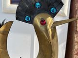 a statue of a bird with a fan on it ' s head