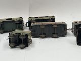 a group of miniature trains sitting on a white surface