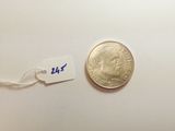 a small coin with a tag attached to it