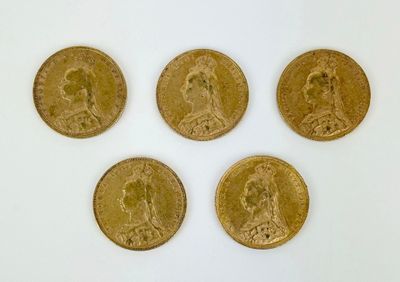 four gold coins are arranged in a row on a white surface