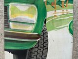 a painting of a green truck on the side of the road