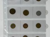 six different coins are in a clear plastic holder on a white surface