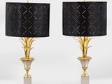 a pair of brass and black lamps with black shades