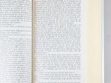 an open book on a table with a white background