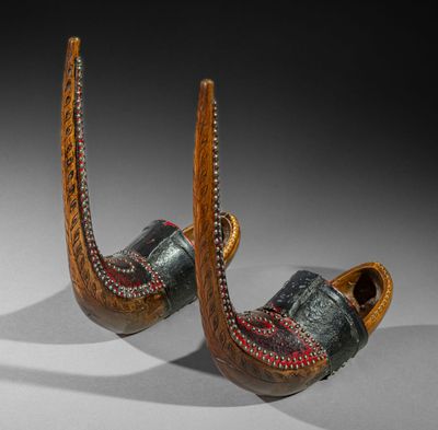 pair of wooden shoes with red and green designs on them