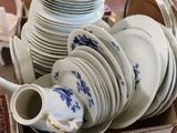 a box full of plates and cups on a table