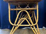 an image of a small table with a wooden top and wicker legs