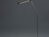 a black desk lamp with a white light on top of it