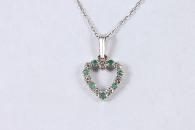 an image of a heart shaped pendant with green stones on a chain
