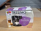a box of tassino coffee maker on the table
