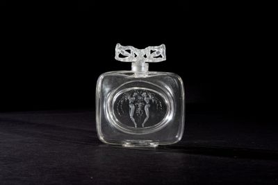 a clear glass bottle with an elephant design on it