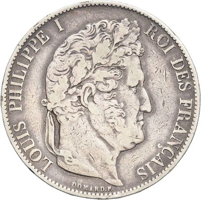 a close up of a silver coin with a man ' s head on it
