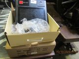 a box with a cell phone inside of it on a table