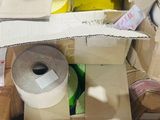 a pile of boxes and a roll of tape on the floor