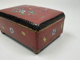 a small red box with a floral design on it