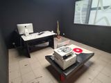 a room with a laptop and a printer on a table
