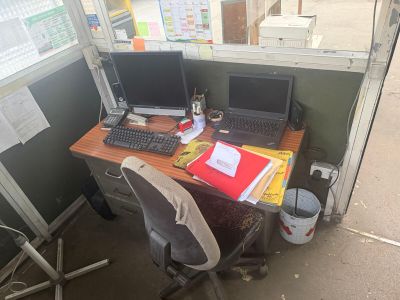 a desk with two computers and a laptop on it